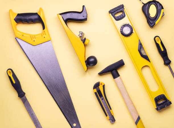 istock Flat layout: a set of hand tools for construction and repair on a yellow background. 1141960479