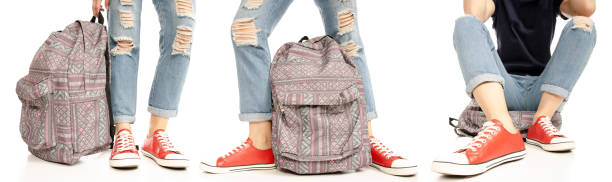 istock Set woman legs feet jeans red sneakers with backpack 1141961249