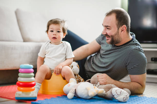 istock Father training his child to use potty 1141961754