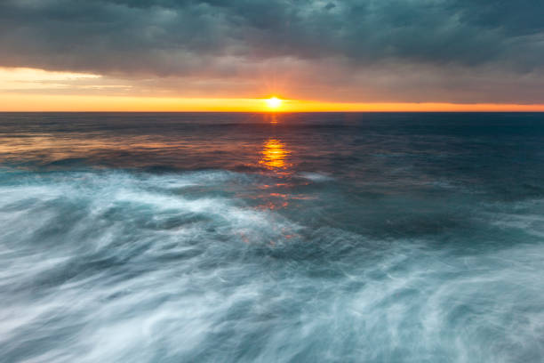 Swirling ocean currents at sunrise