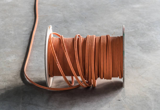 large roll of communications cable on concrete floor at construction site