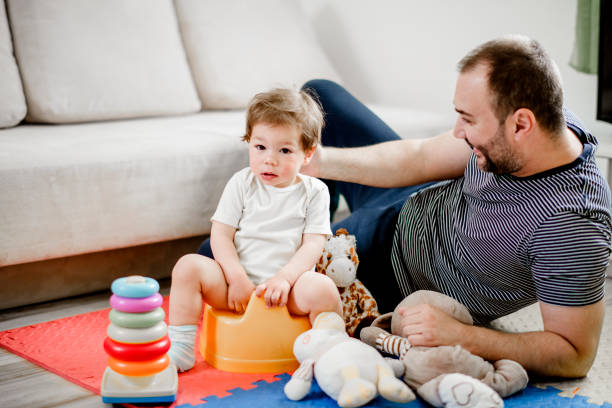 istock Father training his child to use potty 1141963665