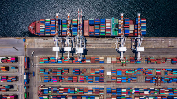 istock Aerial top view container cargo ship unloading in import export business logistic and transportation of international by container cargo ship in the open sea. 1141964559
