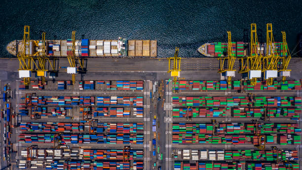 istock Aerial top view container cargo ship unloading in import export business logistic and transportation of international by container cargo ship in the open sea. 1141964562