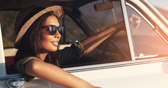 Cropped shot of an attractive young woman enjoying a roadtrip on a sunny day