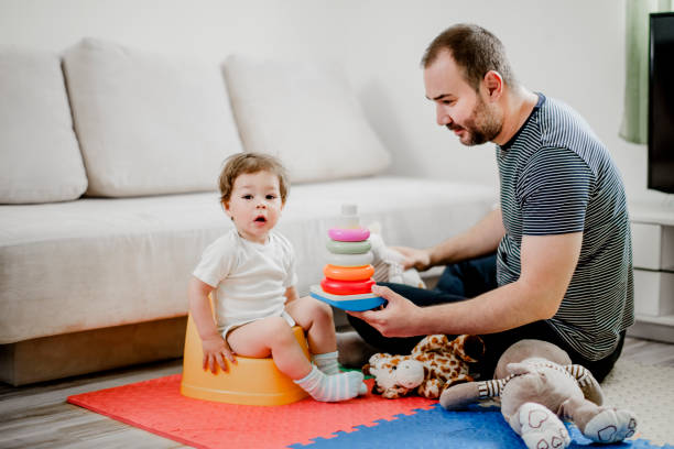 istock Father training his child to use potty 1141967227