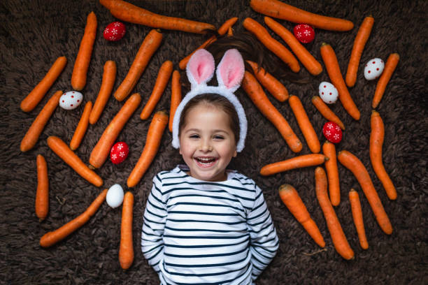 istock Cute girl laying on her carpet with an easter setting 1141968515
