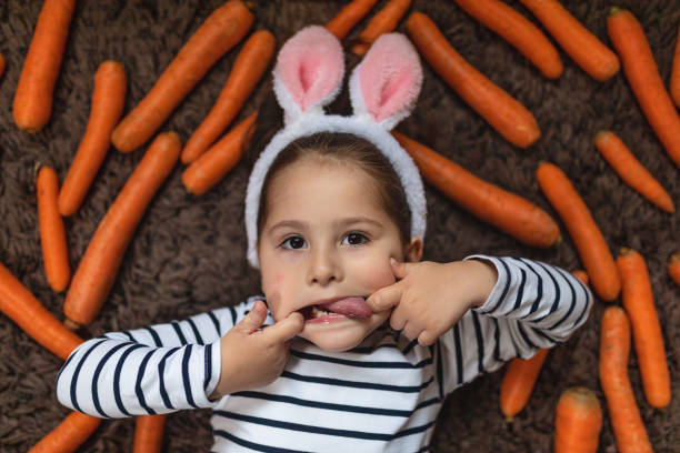istock Small playful bunny girl grimacing at the camera. 1141968519