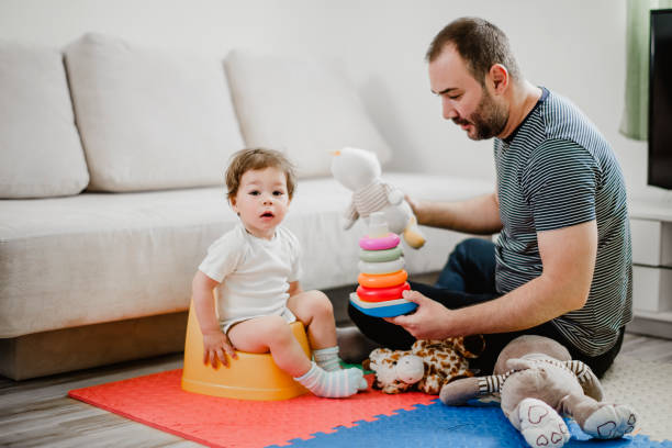 istock Father training his child to use potty 1141968753