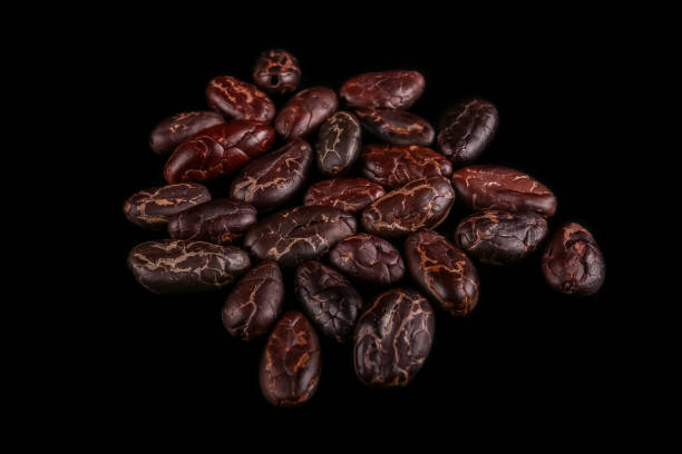 istock Roasted beans. Cocoa beans and coffee beans isolated on black background. 1141969727