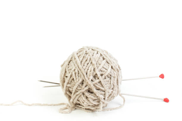 Ball of yarn with knitting needles isolated on white background. stock photo
