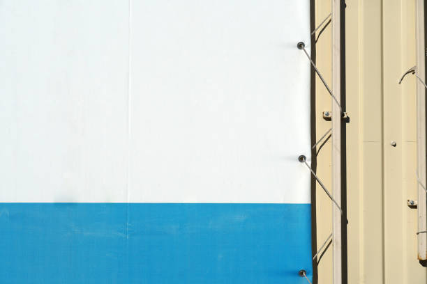istock Fragment empty street banner with fastener elements. Poster edge on metal wall 1141972495