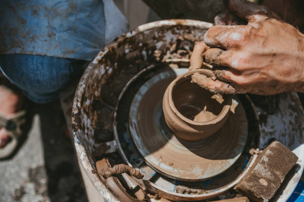 istock Master hands makes a pot of clay. Master class is held in nature, close-up 1141974415