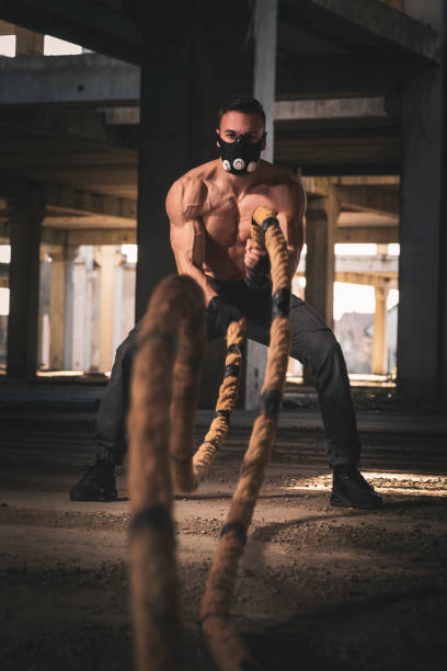 istock Muscular man training with battle ropes 1141974477