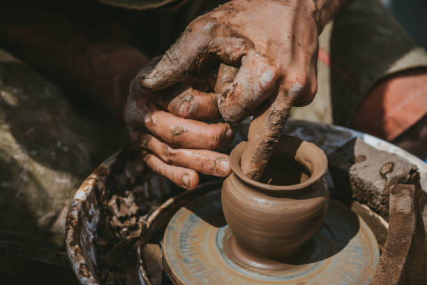 istock Master hands makes a pot of clay. Master class is held in nature, close-up 1141974578