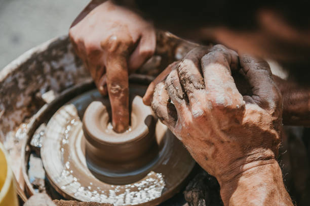 istock Master hands makes a pot of clay. Master class is held in nature, close-up 1141974720