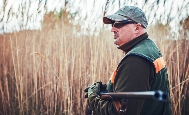 istock Hunter with a rifle in hunting 1141975663