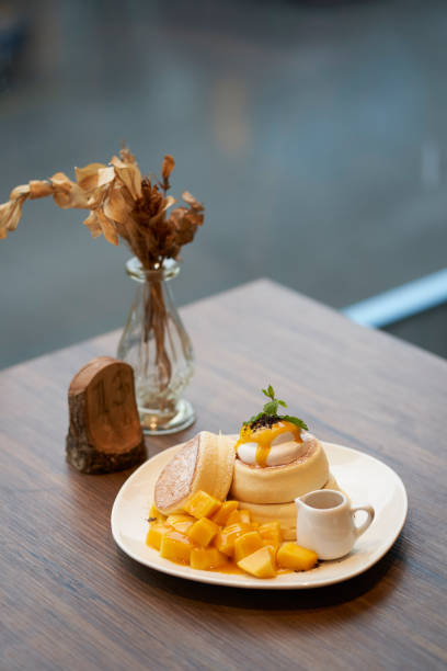 istock Mango cream cheese cake on wooden table 1141975679