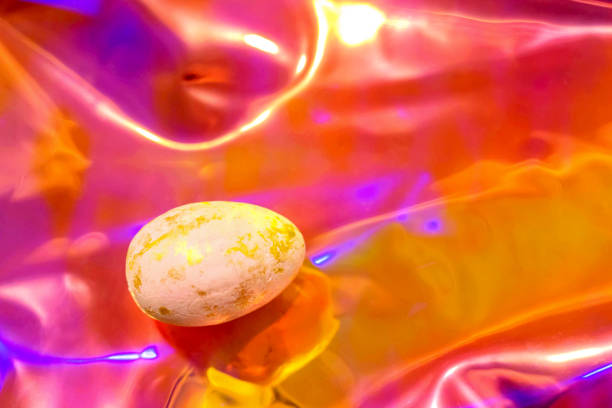 Gold Easter egg on holographic background. Trend of the year.
