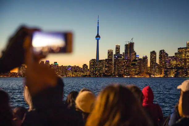 Photo of People photographing the beautiful Toronto skyline at night