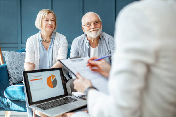 couple aîné avec le consultant au bureau - retirement photos et images de collection