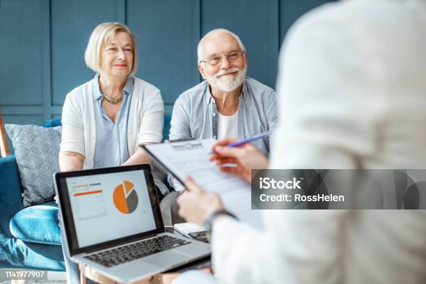 Senior Couple With Consultant At The Office Stock Photo - Download Image Now - Retirement, Senior Adult, Financial Advisor