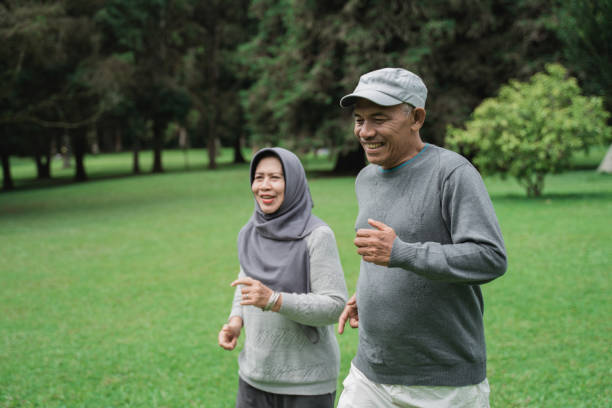 istock couple doing exercising by running in the garden 1141978781