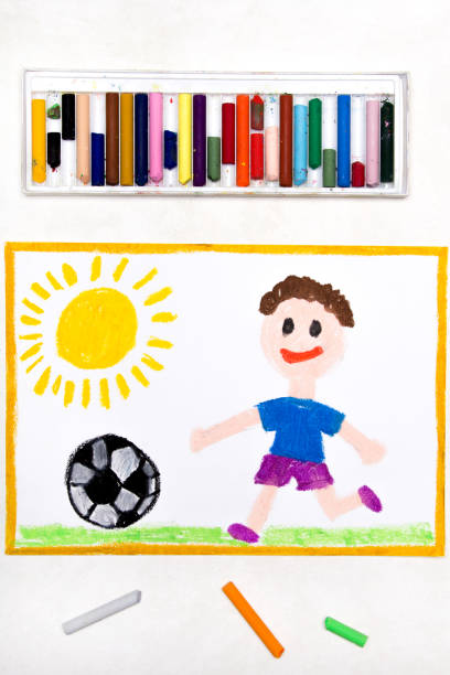 istock Colorful drawing: smiling boy playing football 1141980390