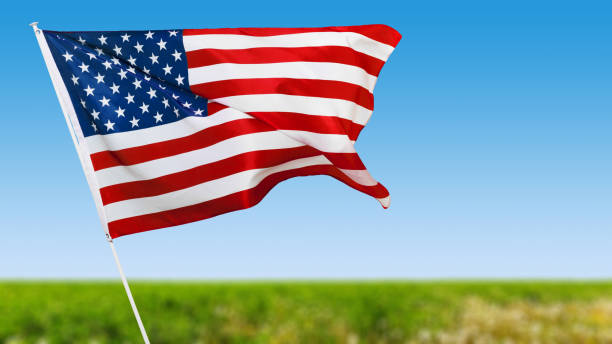 istock American flag against blue sky 1141980706