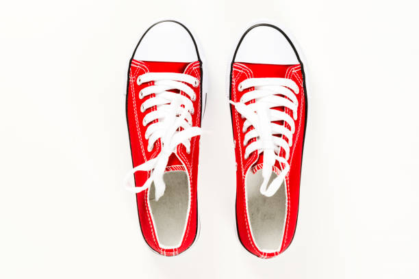 istock Red sneakers top view close up isolated on white background 1141982293