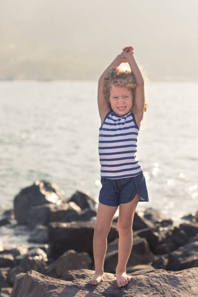 istock Little girl with raised hands 1141982485