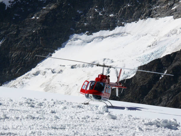istock Red helicopter on high mountain snow 1141984045