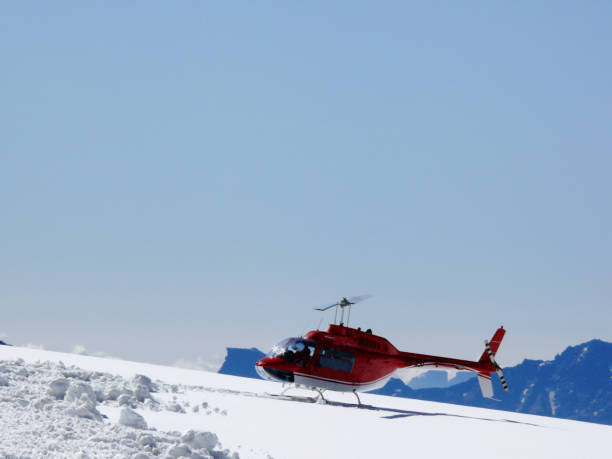 istock Red helicopter on high mountain snow 1141984126
