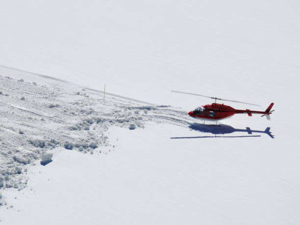 istock Red helicopter on high mountain snow 1141984445