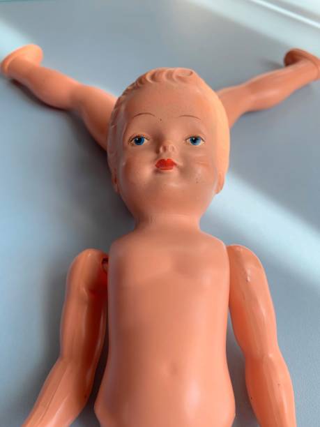istock Damaged vintage doll on blue background 1141985292