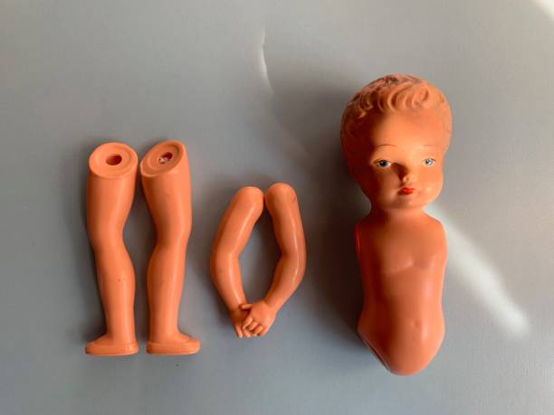 istock Damaged vintage doll on blue background 1141985315