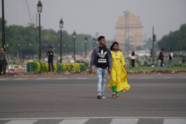 Delhi, India - 16 March 2019: A couple crossing road.