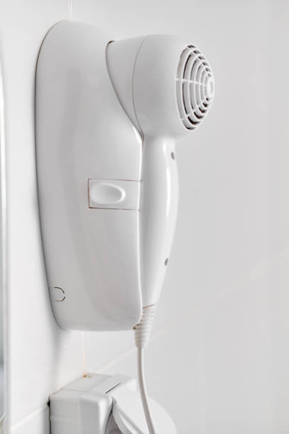 istock Hair dryer over white wall 1141986795
