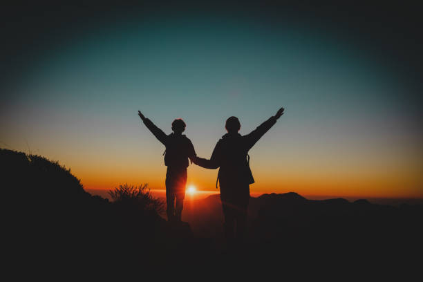 istock Happy father and son hiking at sunset mountains 1141987215