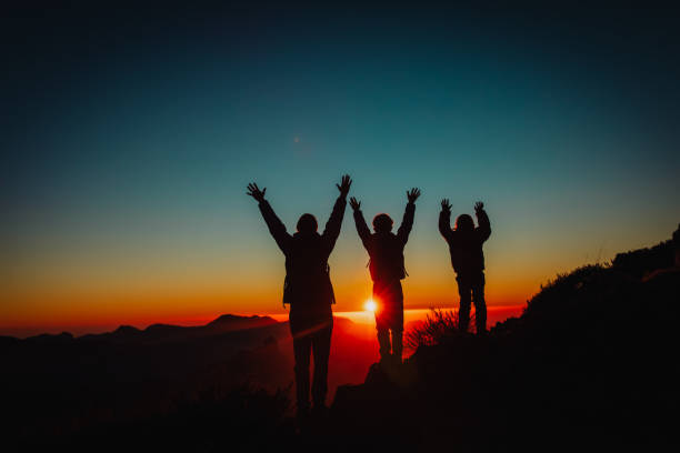 istock Happy father and kids hiking at sunset mountains 1141987237