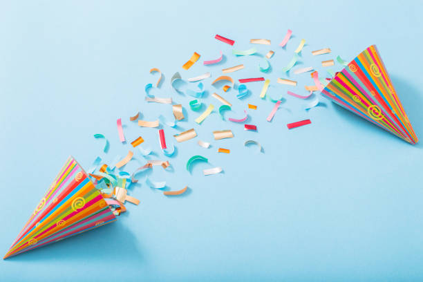 istock birthday hat with confetti on paper background 1141987651