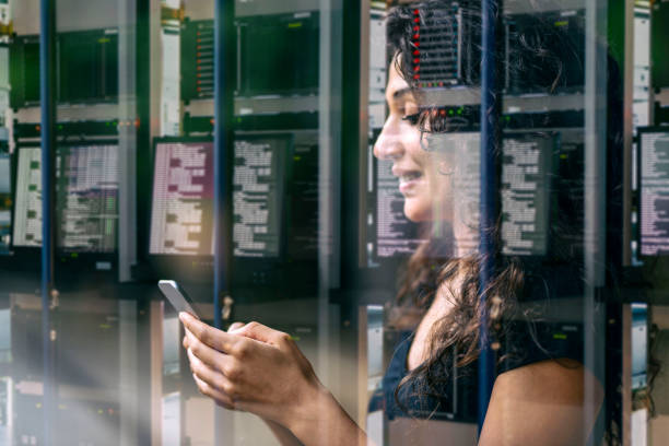 istock Woman's hand using smart phone reflection of data center and network servers, double exposure 1141989474