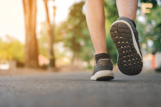 istock Man running on the park with Close up shoes 1141989567