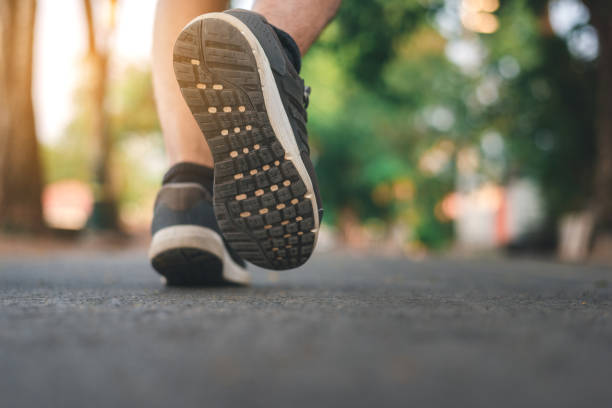 istock Man running on the park with Close up shoes 1141989581
