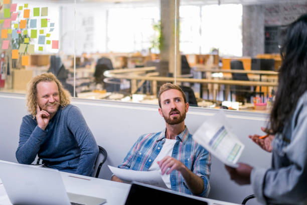 istock Colleagues looking at manager giving presentation 1141989625