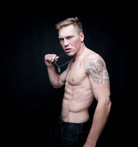 istock Handsome shirtless man wearing a dogtag 1141989709