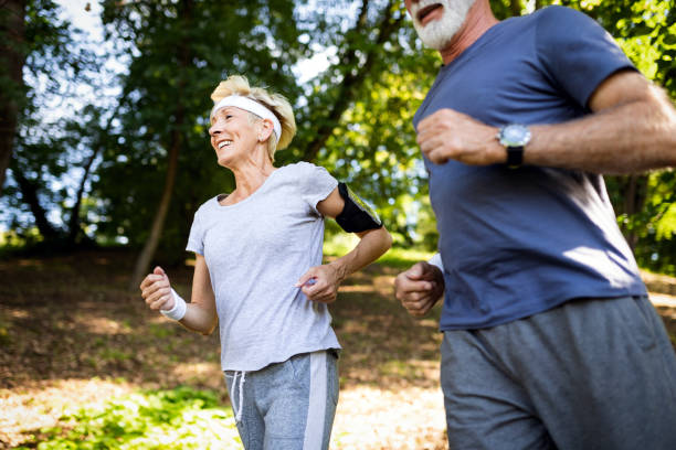 istock Senior couple jogging and running outdoors in nature 1141989861