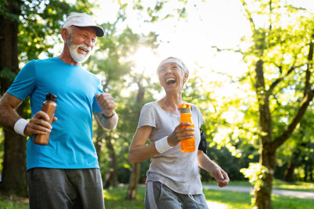 istock Senior couple jogging and running outdoors in nature 1141989953
