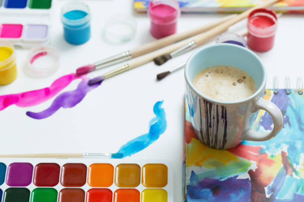 istock paints, brushes and cup of coffee on paper 1141991069
