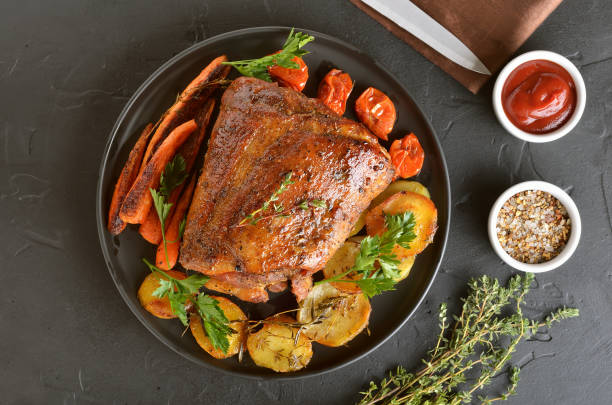 istock Baked pork, fried potatoes and carrots 1141991314
